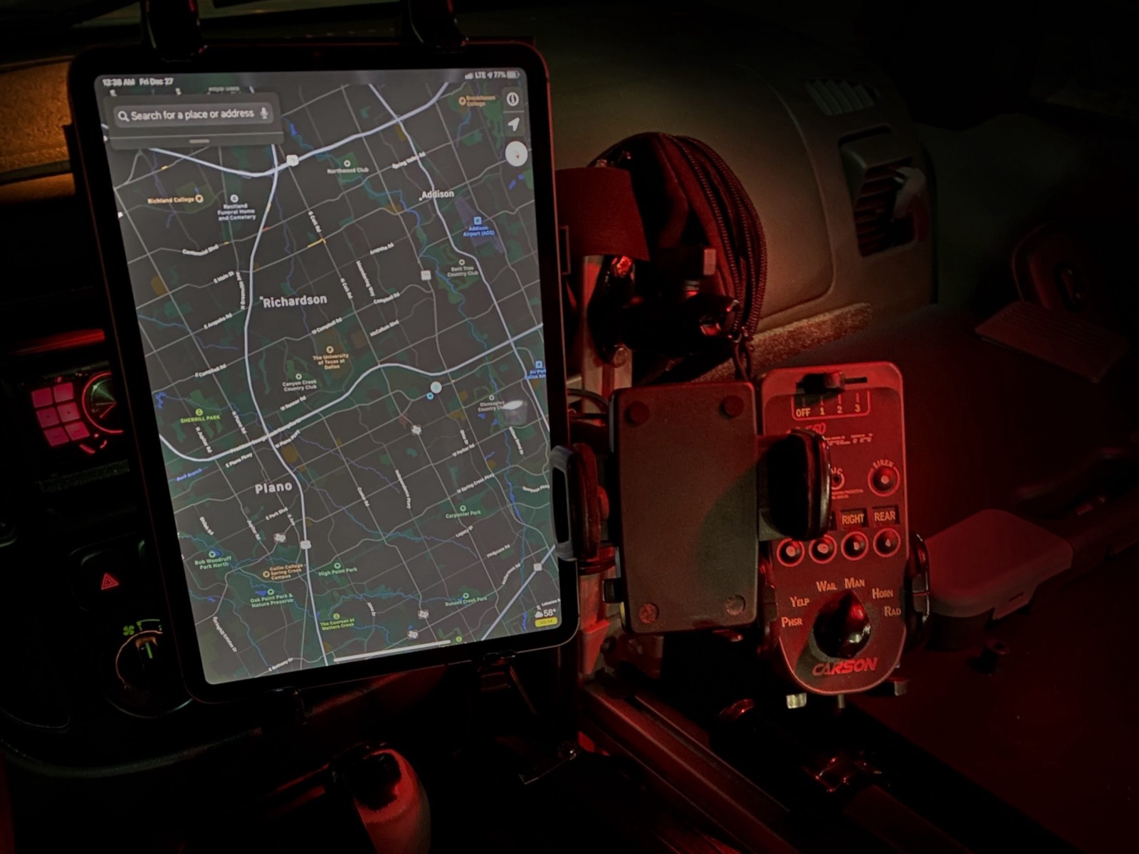 Inside an ISG patrol vehicle at night: the map tablet and light controls